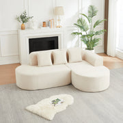 Divano angolare a L in velluto a coste beige con due moduli schienale e braccioli curvi con tre cuscini